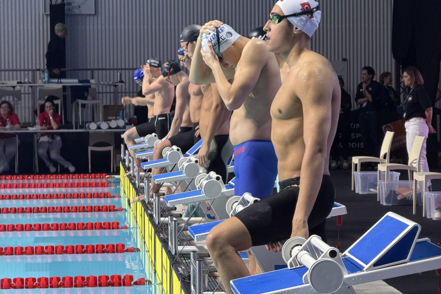 elite swimmers preparing for race start during SwimCup Lausanne live sports event