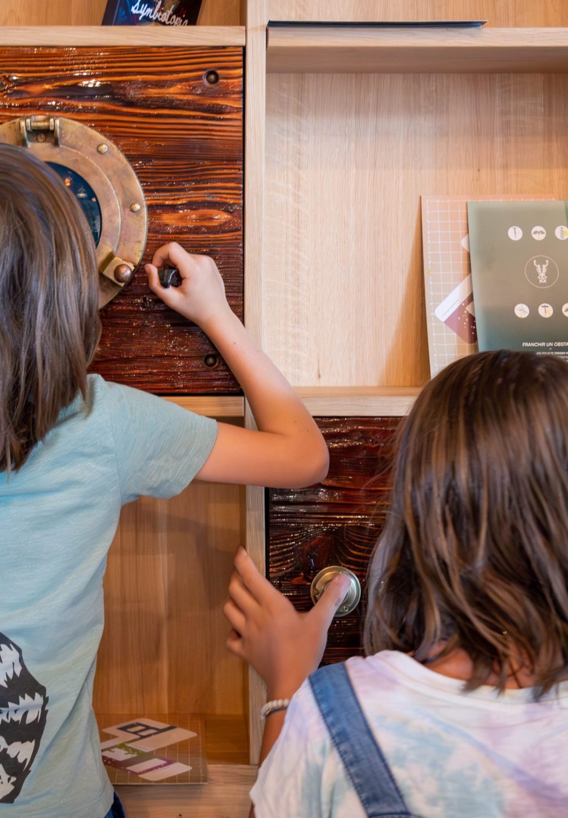 Interactive wooden installation with buttons and circular features used by children during the MEA – Opening of MEA at Geneva.