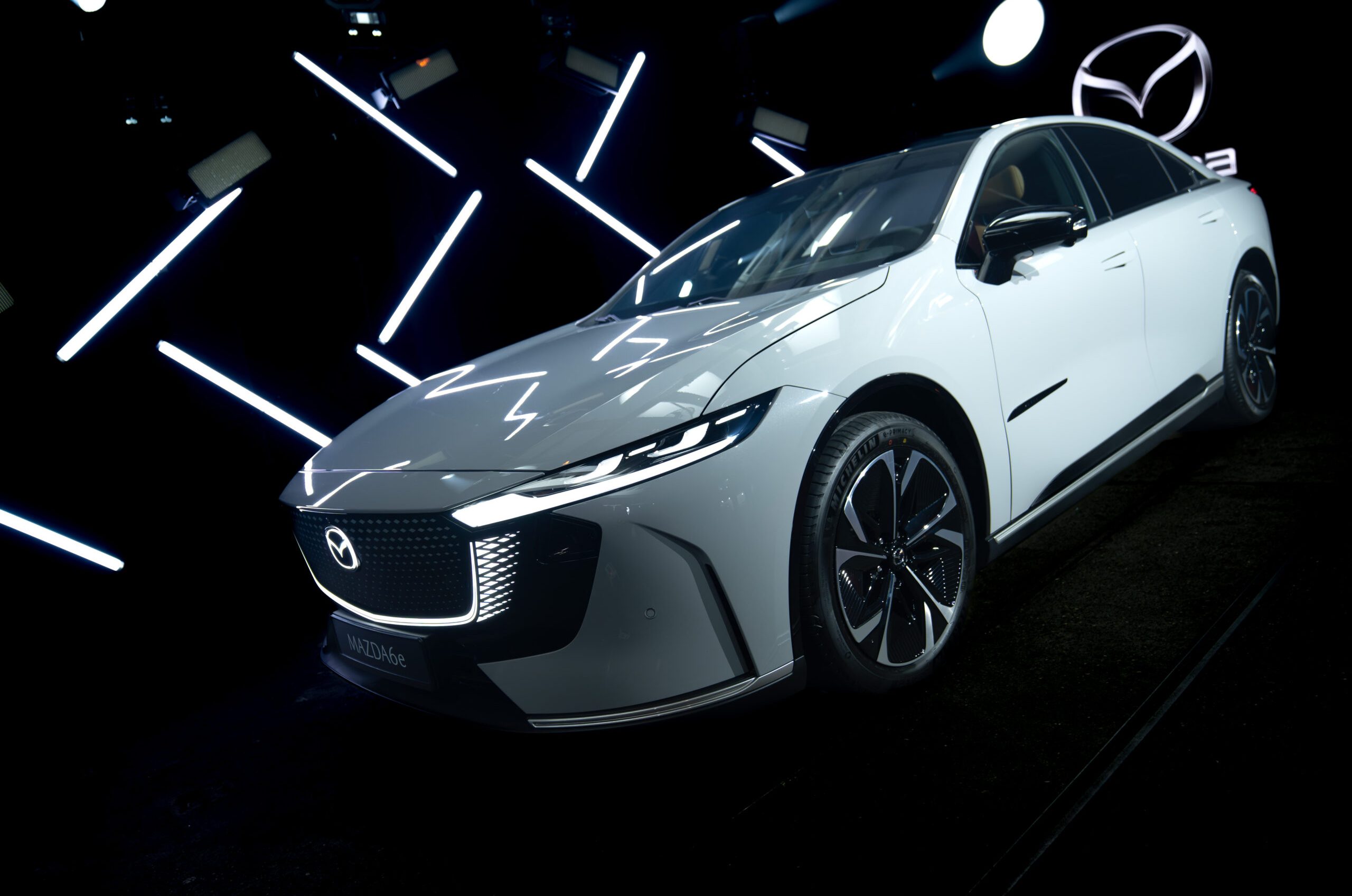 Mazda 6E displayed in a cinematic lighting environment with geometric light elements during the Mazda – Cinematic reveal of the Mazda 6E.