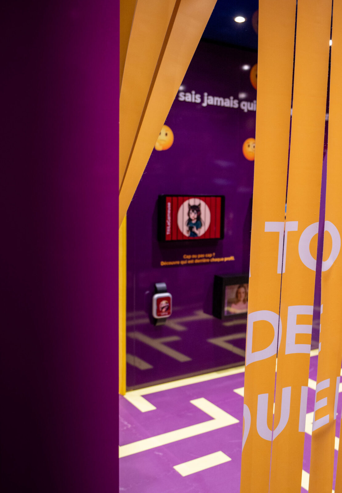 Partial view of a scenographed corridor where color palettes, typography, and spatial design guide visitors through the different educational modules of the pavilion.